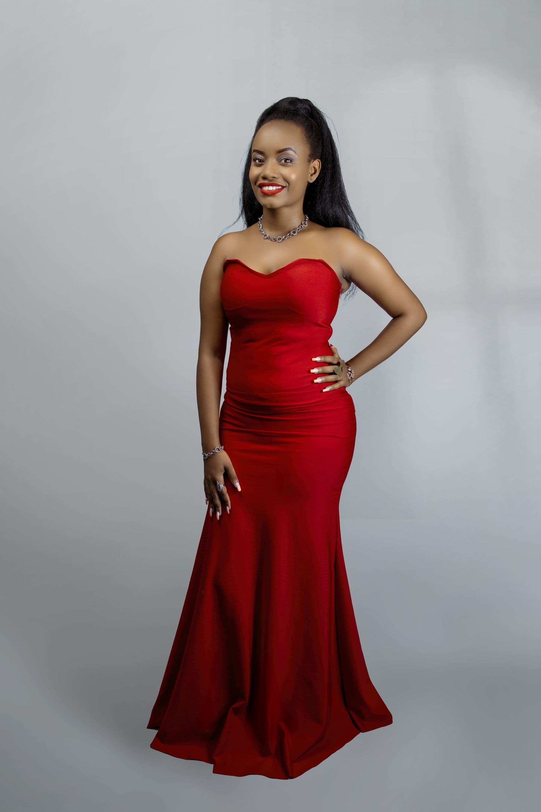 Concept evening look featuring a woman in a long red dress