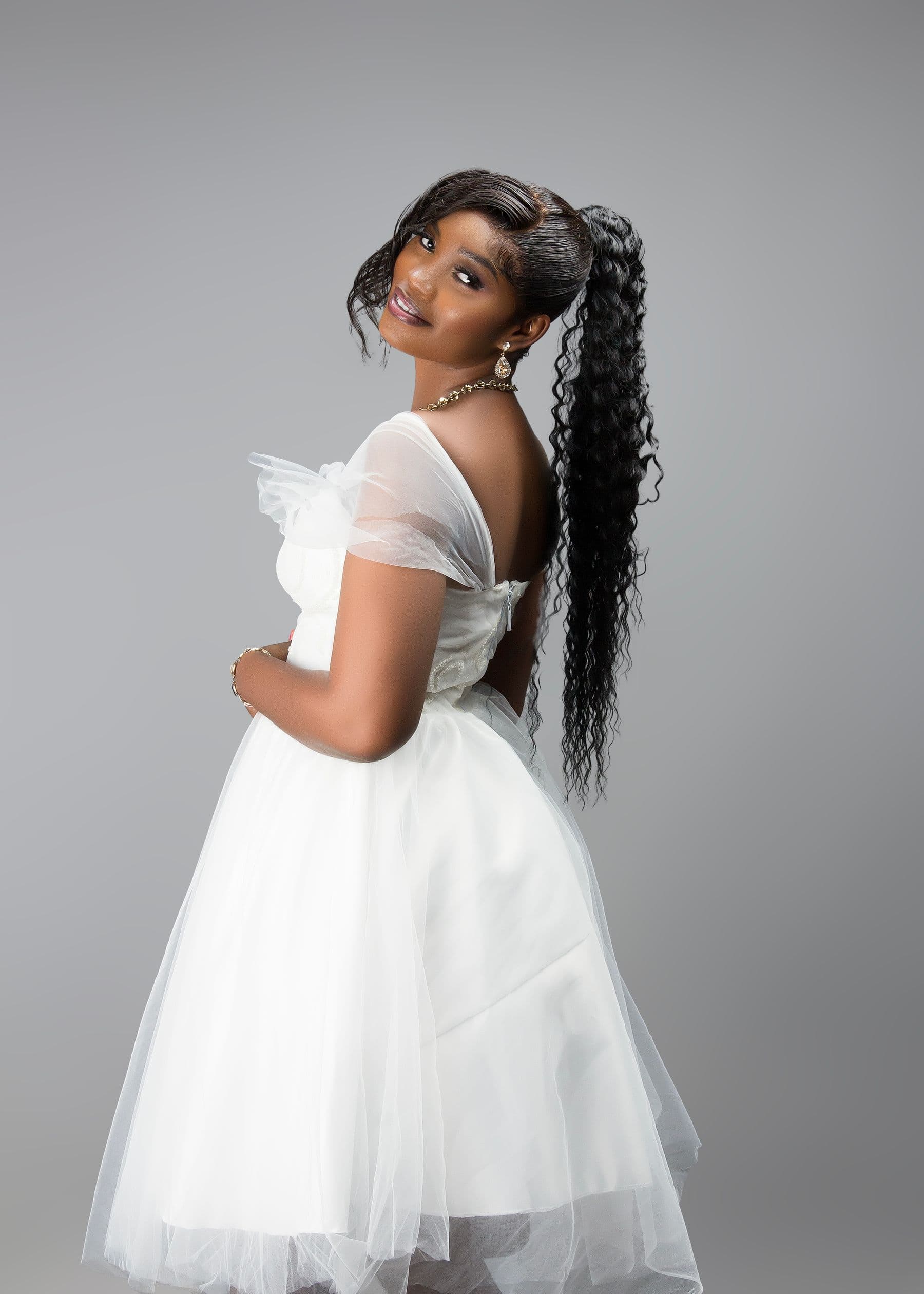 Concept neutral look featuring a woman in a flowing white dress