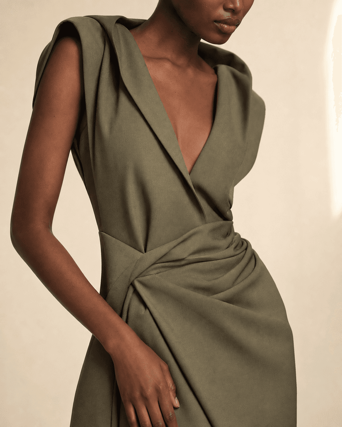 Concept close-up of an olive dress neckline and waist draping